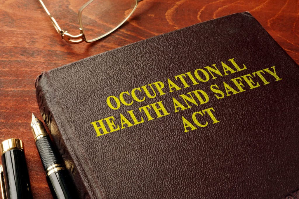 Occupational Health and Safety Act book, glasses, pens