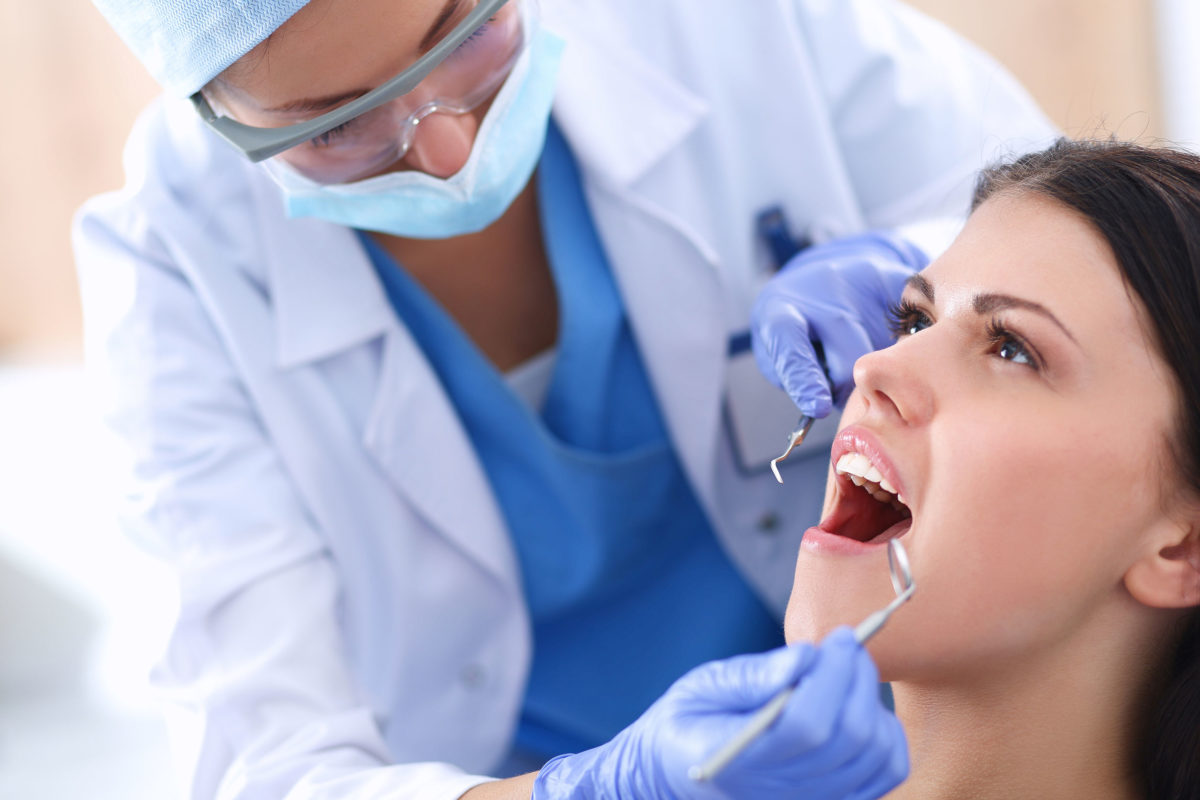 43397789 - woman dentist working at her patients teeth . - The SMART Choice